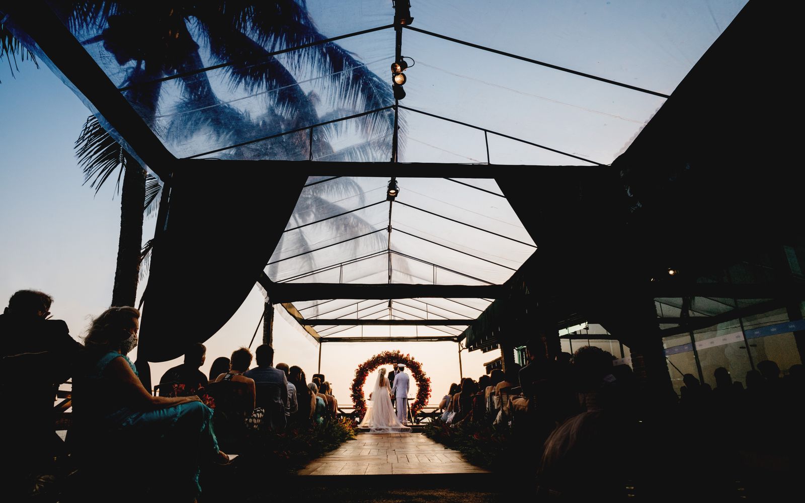 Beach wedding ceremony with pampas grass and a driftwood arch